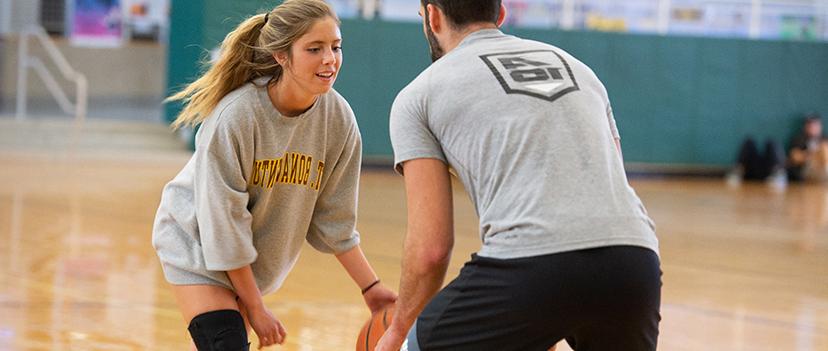 Students playing basketball in the Richter Fitness Center